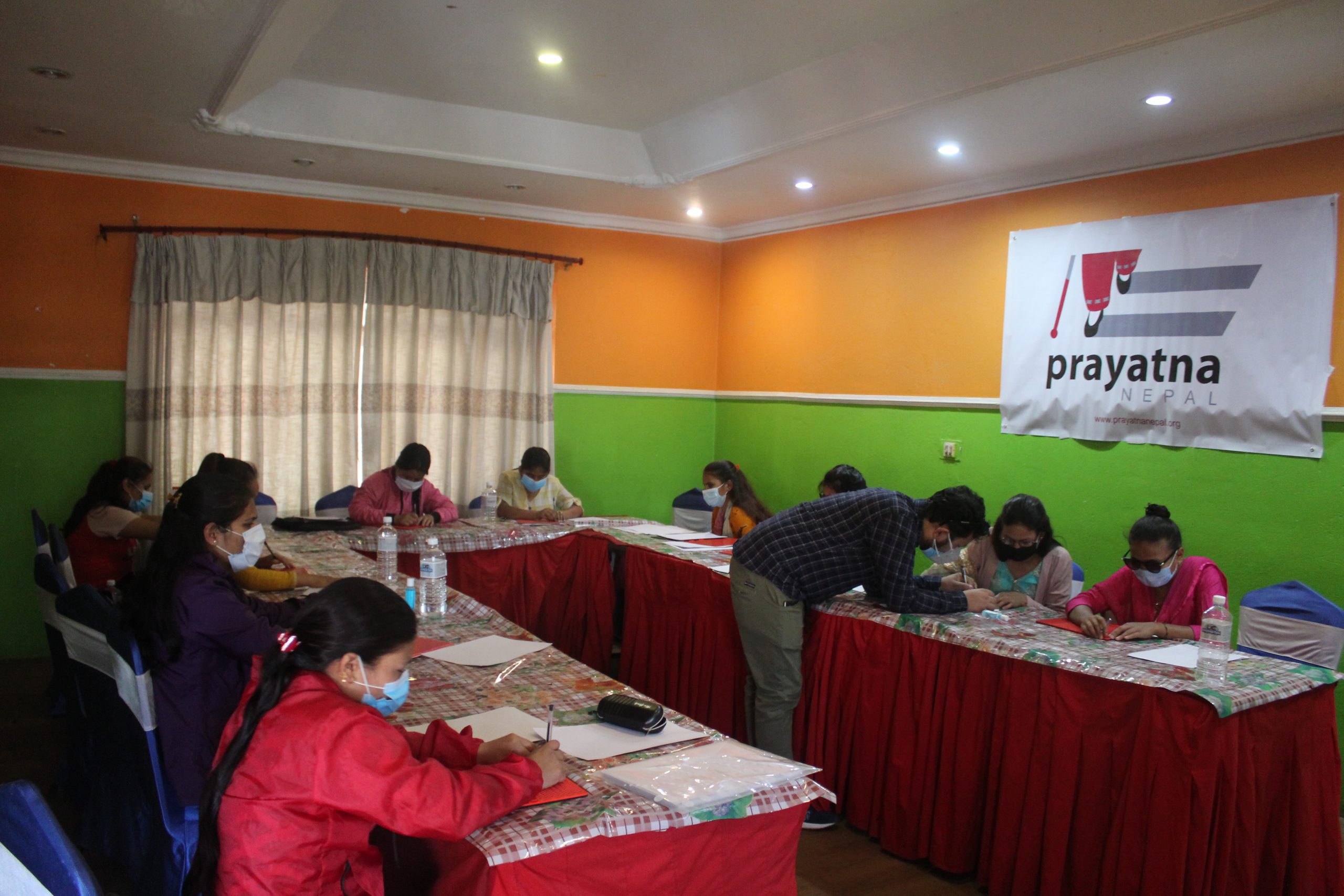 All participant writing their name on paper