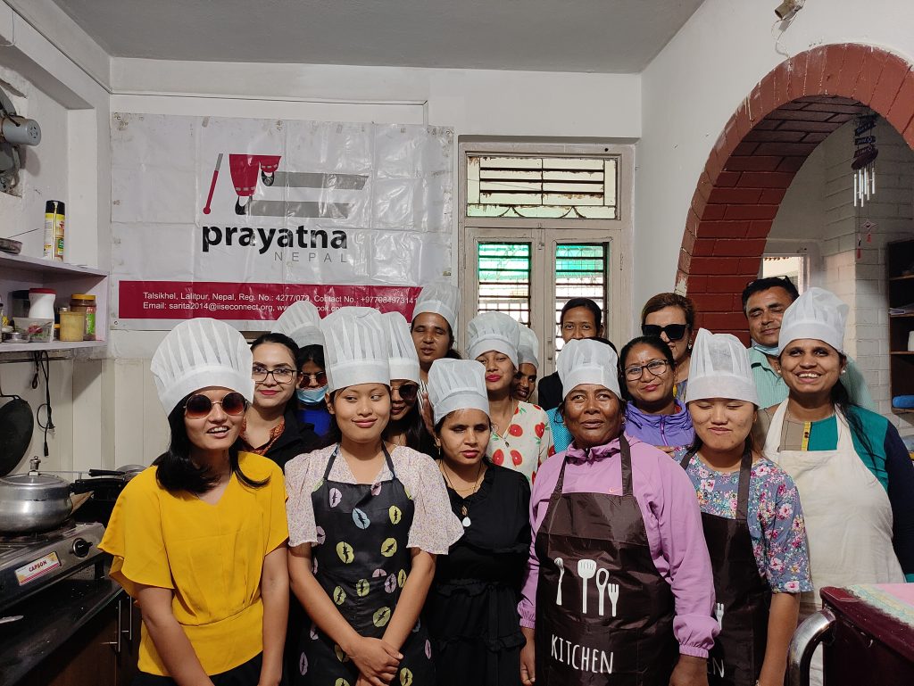Participants and Prayatna nepal team taking a group photo in the kitchen during training